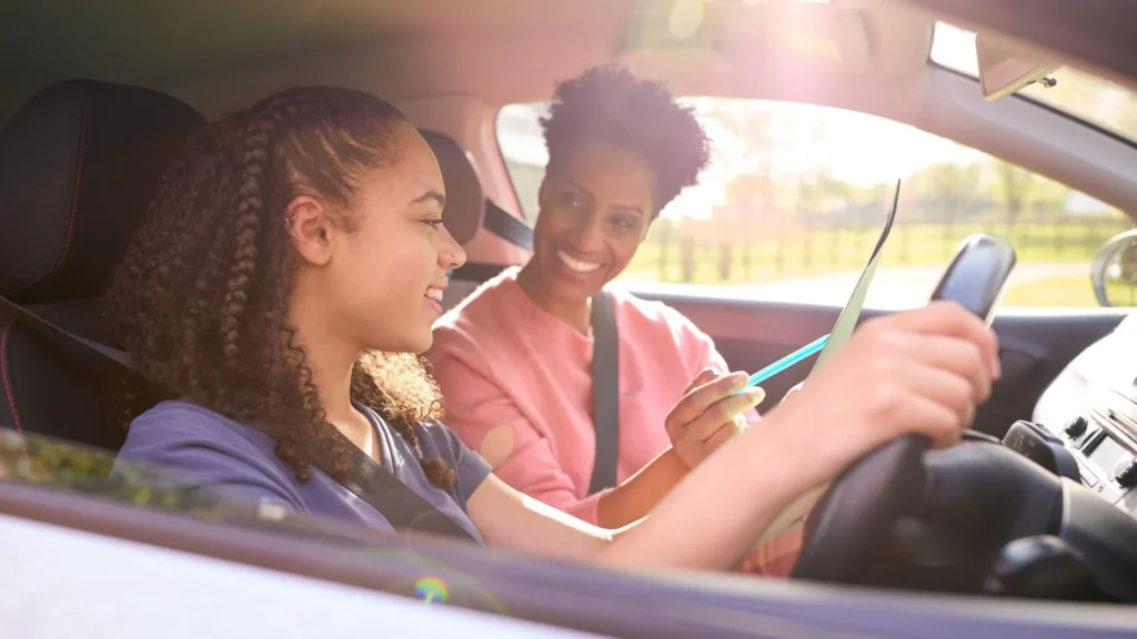 New driver practicing defensive driving techniques with instructor