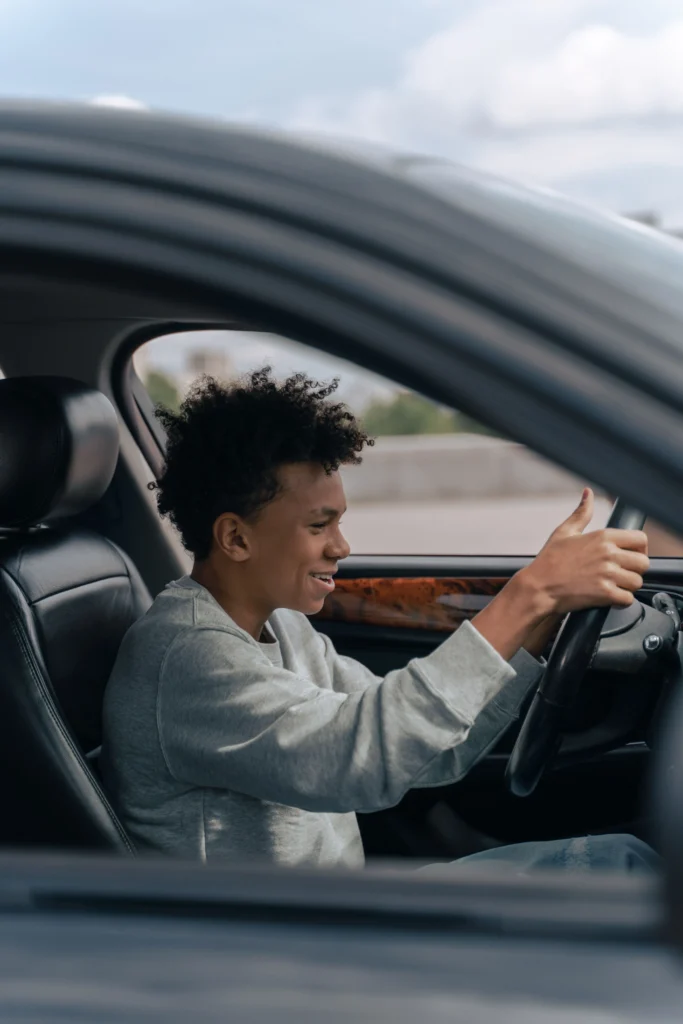Student enjoying a successful first driving lesson with instructor