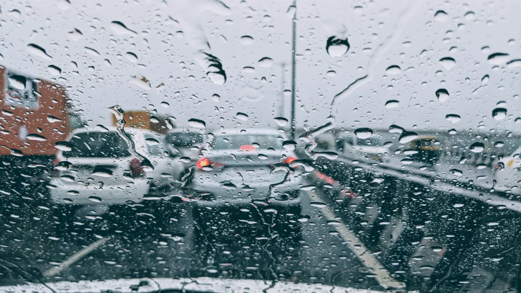 Driver applying defensive driving techniques during rainy weather