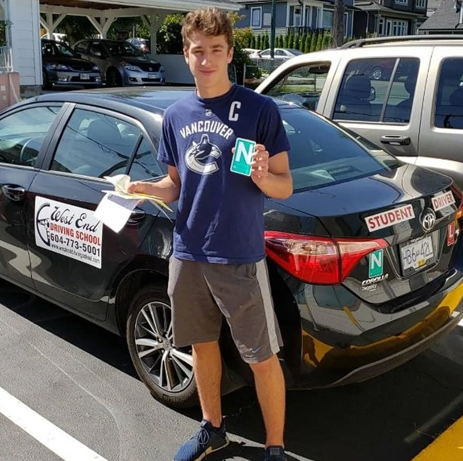 New driver holding N sign after driving school vancouver training