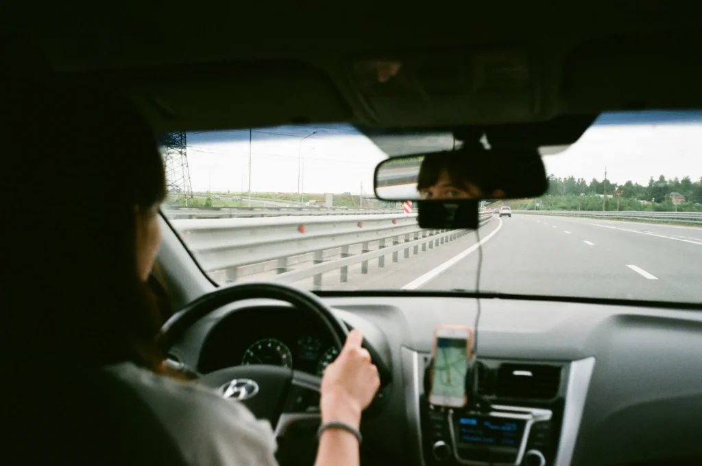 Driver avoiding road test mistakes by checking blind spots
