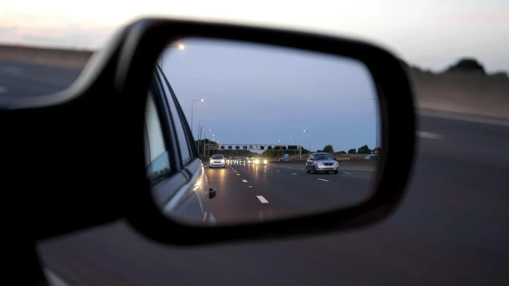 Driver checking mirrors using defensive driving techniques
